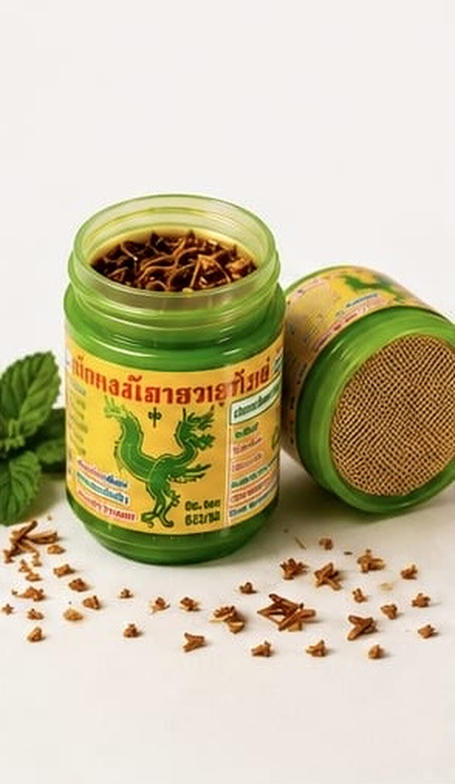 Hong Thai jar opened to show the herbal fibre fill alongside fresh mint leaves